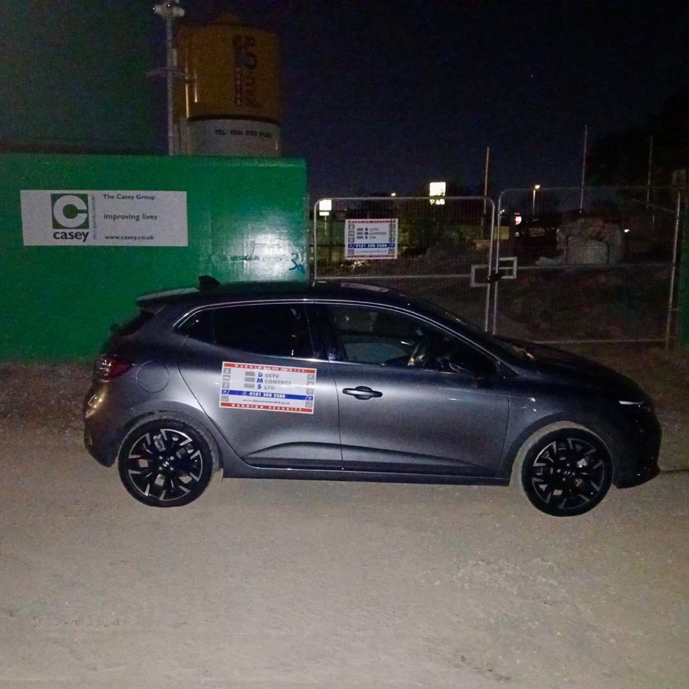 DMS patrol car outside a site at night