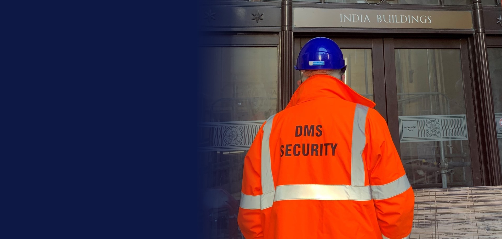 DMS security officer in a DMS Security hi-vis jacket outside India Buildings, Liverpool