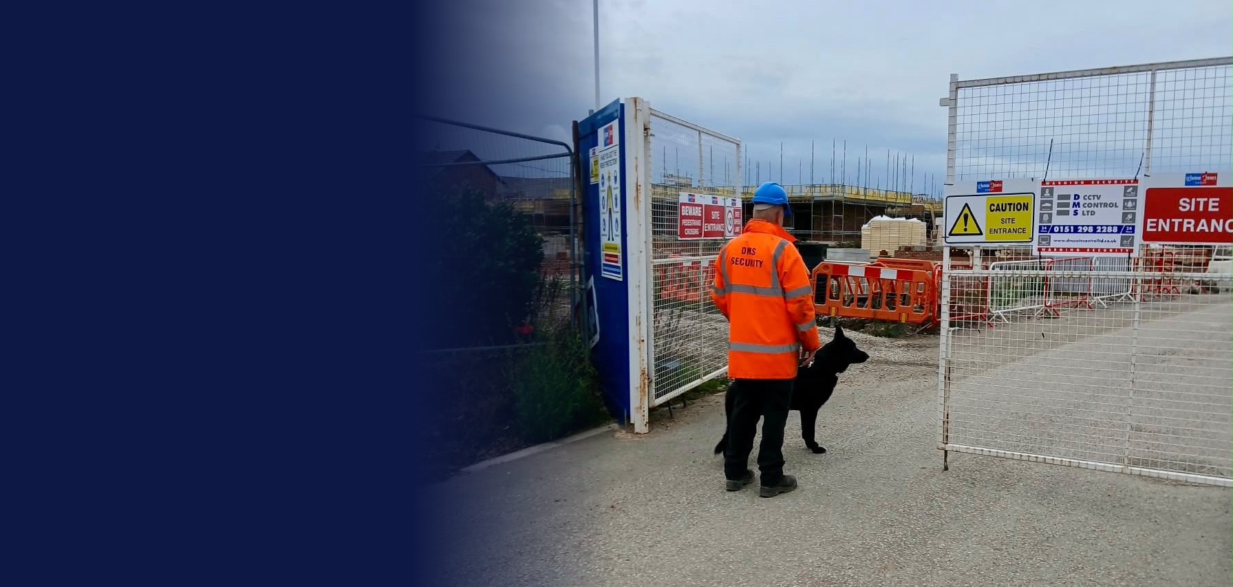 DMS dog handler and guard dog at a site entrance