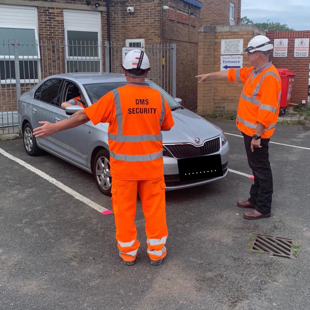DMS traffic marshals in hi-vis directing a car